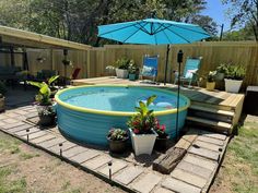 an above ground pool surrounded by potted plants