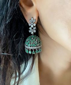 Elevate your style with our Statement Mint Green Diamond Jhumkis or Victorian Emerald Green Jhumkis. These elegant earrings are perfect for all-time wearing, adding a touch of sophistication to any outfit. Ideal for special occasions and everyday elegance, these jhumkis are a must-have addition to your jewelry collection. Earrings are 2 inches Long  A Earring Weight is 0.5 oz  All our products are crafted using traditional skills from our rich heritage. The manual nature of these crafts means th Luxury Green Hand Set Jhumkas, Green Fusion Style Chandbalis With Cutdana, Green Cutdana Chandbalis In Fusion Style, Green Cutdana Fusion Chandbalis, Green Fusion Jhumkas For Diwali, Green Cutdana Jhumkas For Celebration, Celebration Green Cutdana Jhumkas, Green Fusion Style Jhumkas With Tilla Detail, Green Tilla Jhumkas For Party