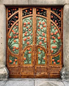 an ornate wooden door with oranges on it