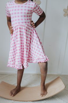 Be a fashion trendsetter in this PINKNIC GINGHAM DREAM RUFFLE DRESS! This fun and flirty dress is the perfect mix of style and comfort – it looks just as good twirling at a picnic as it does at a party! Featuring pink gingham fabric, dreamy ruffles, and a fit that'll have your girl glowing, any day spent in it will be a dream come true. Let her take center stage! Made from the softest and most breathable seasonal bamboo viscose material, your babe won't want to take this off! Designed for all th