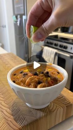 a person is spooning some food into a bowl