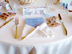 the table is set with white linens and silverware