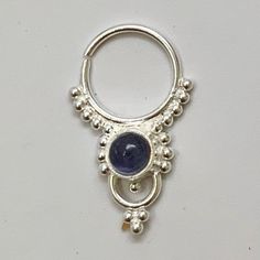 "These are soooooo pretty. Made is 925 sterling silver with tribal details, set with an alluring tanzanite stone. The rings are all 1cm (.40\") in diameter. The wire is 18 gauge. Each piece is made BY HAND so there may be very slight differences One of the images contains numbers to specify which you would like from the drop down menu." Sterling Silver Body Jewelry As Gift, Spiritual Silver Amethyst Ring In Sterling Silver, Spiritual Silver Body Jewelry For Gift, Sterling Silver Body Jewelry, Unique Sterling Silver Body Jewelry Gift, Unique Sterling Silver Body Jewelry For Gifts, Celestial Sterling Silver Jewelry, Silver Amethyst Hypoallergenic Jewelry, Silver Tanzanite Round Jewelry