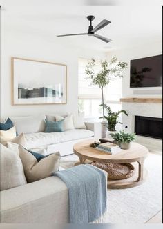 a living room filled with furniture and a flat screen tv mounted on the wall above a fireplace