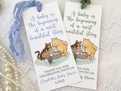 two bookmarks with winnie the pooh and tigger on them sitting next to pearls