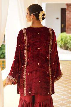 Maroon straight kurta with gold zardosi, aari and kundan embroidery. Paired with a gharara and dupatta.
Components: 3
Pattern: Embroidered
Type Of Work: Zardosi, Aari, Kundan
Neckline: U Neck
Sleeve Type: Flared
Fabric: Kurta: Silk Velvet, Gharara: Satin Silk, Dupatta: Organza
Color: Maroon
Other Details: 
Approx. product weight: 1.5 kg
Length:
Kurta: 33 inches
Gharara: 38 inches
Note: Outfit worn by the model on the right is not for sale.
Occasion: Mehendi and Haldi - Aza Fashions Festive Nida Sharara With Dabka Work, Red Sets With Dabka For Traditional Ceremonies, Wedding Velvet Sets With Dabka Work, Eid Sharara With Zari Work, Festive Kundan Sharara With Dabka Details, Anarkali Velvet Sharara For Wedding, Velvet Anarkali Sharara For Wedding, Wedding Velvet Traditional Wear With Dabka, Velvet Wedding Traditional Wear With Dabka