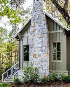 a small stone house with stairs leading up to it