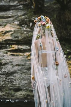 a woman wearing a veil with flowers on it