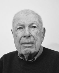 an old man with wrinkles on his face looking at the camera, black and white photo