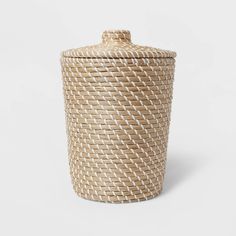 a large woven basket with lid on a white background