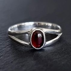 💖  Product Description Dainty Garnet Ring - Oval 925 Sterling Silver Garnet Ring Garnet is the January Birthstone and 2nd Anniversary Gemstone 💖 Product Details *  925 Sterling Silver *  Handmade *  Total Ring Length - 8mm *  Stone Size - 7mm x 5mm *. Stone Height - 3mm *  Weight - 2.8g *  Band Width - 3mm 💖 Ring Sizing If you're unsure of your finger size, please purchase the reusable plastic ring sizers we have available and follow the instructions in the FAQ section to determine your finger size.  Please note your knuckle size too.   US Sizer - https://www.etsy.com/uk/listing/1122628075/ring-sizer-us-us-sizes-1-17-free UK Sizer - https://www.etsy.com/uk/listing/1108679592/ring-sizer-uk-uk-sizes-a-z9-free If you prefer not to buy a ring sizer, please refer to the Sizing Guide in the F Supernatural Dr, Garnet Ring Silver, Sterling Silver Garnet Ring, Boho Jewellery, Everyday Ring, 2nd Anniversary, Dope Jewelry, Downtown Girl, Red Gemstones