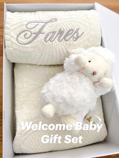 a welcome baby gift set in a white box with the words fales on it