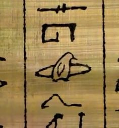 an ancient egyptian hieroglyic sign with symbols and writing on wood paneling