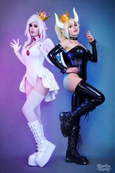 two women dressed in cosplay costumes posing for the camera