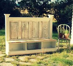 an old bench with baskets on it and a chair next to it in the grass