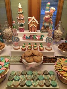 a table topped with lots of cookies and cupcakes