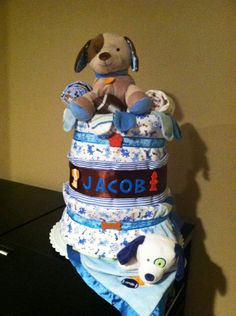 a teddy bear sitting on top of a stack of diapers