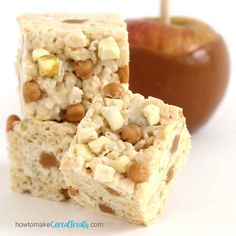 two pieces of rice krispy treats are stacked on top of each other next to an apple