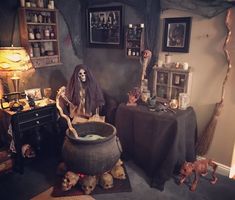 a living room decorated for halloween with skeletons and skulls on the floor, candles and other decorations