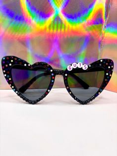 This listing is not affiliated with Olivia Rodrigo's GUTS Tour Merchandise. GUTS World Tour Glasses Black Heart Shaped Glasses / Black Lenses Purple/Pink/Blue/Dark Blue/White/Silver Foil Stars Black Gems on bottom/bridge Fun Black Sunglasses For Parties, Fun Black Sunglasses With Glass Lenses, Fun Black Glass Sunglasses, Bedazzled Glasses, Dark Purple Accessories, Guts Olivia Rodrigo, Tour Merchandise, Guts Tour, Heart Shaped Glasses