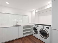 a washer and dryer in a white laundry room