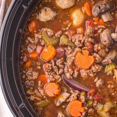 a crock pot filled with meat and vegetables