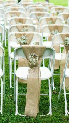 rows of white folding chairs with burlocks tied to them