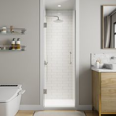 a bathroom with a toilet, sink and shower stall in the corner next to a wooden cabinet