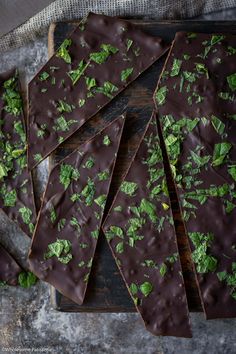 chocolate barkle with mint sprigs on a cutting board next to a knife