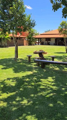 a park bench sitting in the middle of a lush green field