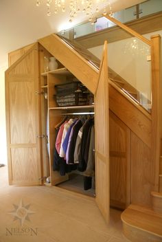 an open closet with clothes hanging in it