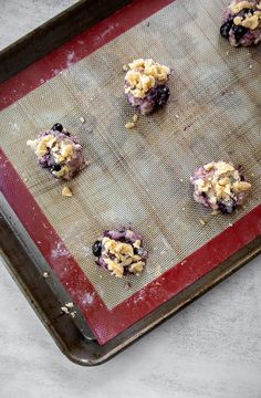 blueberry muffins on a baking sheet ready to go into the oven