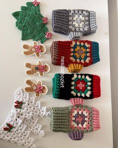 several crocheted mittens are lined up on a table