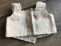 "Antique French Doll Corset, Eyelet Lace, Tea Stained Ecru Cotton, Doll Clothing ja 12182110 Rare French ecru cotton doll corset (stay). A rare find. Two crossover ties and a. tiny belt with a mother of pearl button closure. Tiny eyelet lacing around the arms. Ribbed cotton and linen lined. Measures; 8.5\" across or 17\" circumference, 5.5\" height. We left as found with heavy tea staining for period clothing projects. It is a little darker in person as the photo was taken in indirect exterior l Sullen Girl, Doll Corset, Frye Riding Boots, French Shoes, Clothing Projects, Book Dress, Cotton Doll, Period Clothing, Period Outfit