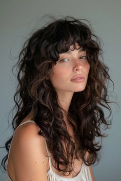 Are you ready to ditch the flat iron and embrace your naturally curly hair? Look no further than these 25 stunning layered curly haircuts that will make you fall in love with your unique texture. Soft Shag Wavy Hair, Medium 2c Haircut, Curls Bangs Long Hair, Witchy Long Hair, Long Hair Perm With Bangs, Types Of Haircuts For Curly Hair, Wavy Long Wolf Cut, Curly Hair Butterfly Haircut, Shaggy Long Hair Curly