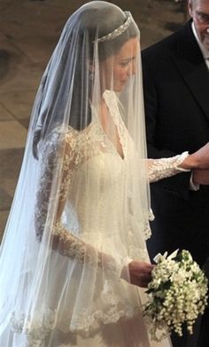 the bride and groom are walking down the aisle at their wedding ceremony in black and white