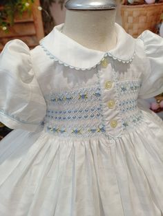 Baby-smocking dresses and girl-smocked dresses made in Spain by handicrafts artisans, since 1989 kid's clothes manufacturers. The best quality.  Front and back smocking dress, 100% handmade in Spain, stitch by stitch!  This is made in LUXURY PALE LEMON COTTON SATIN, a soft and comfortable dress. White peter pan collar and cuffs, with lilac feather stitching, and little dots in lemon threads. Back buttoned, standard holes.  It comes with matching frilly bloomers, and hair accessories. In the smaller sizes with headband with removable bow, in the bigger sizes hair clip bow. Fully cotton-lined. With TULLE UNDER PETTICOAT included!  If you need another size, please, contact us by WhatsApp +34 682441998. If you need a matching boy's suit, just contact me. We can make it.  The usual manufacturin Luxury Cotton Smocked Dress With Smocked Back, Cotton Smocked Dress For Baptism, Playful Cotton Smocked Dress With Smocked Back, Frilly Bloomers, Smocking Dress, Cotton Baptism Dress With Smocked Bodice, Hand Smocked Dress Smockingbird, Smocked Baby Clothes, Hand Smocked Dress