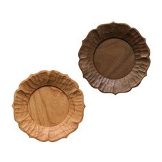 two wooden plates sitting next to each other