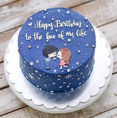 a blue birthday cake decorated with cartoon characters on the top and writing happy birthday to the love of my life