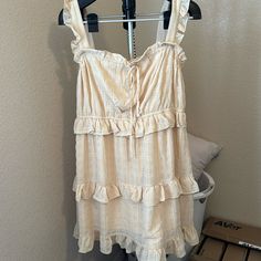 Cream Colored Ruffled Knee Length New With Tags Size L Stretchy Casual Cream Sundress With Ruffles, Cream Ruffled Sundress For Vacation, Chic Beige Sundress With Ruffles, Casual Beige Sundress With Ruffles, Beige Ruffled Casual Sundress, Casual Beige Ruffled Sundress, Cream Knee-length Sundress, Summer Beige Mini Dress With Ruffle Hem, Cream Ruffled Sundress