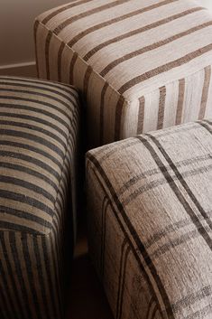 two striped couches sitting next to each other