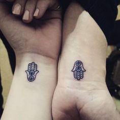 two people with matching tattoos on their arms