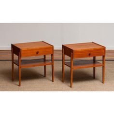 two wooden end tables sitting on top of a carpeted floor next to each other