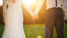 a bride and groom hold hands as the sun shines behind them in this photo