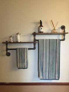 two towels hanging on the wall next to each other in front of a towel rack