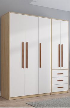 a white and wood wardrobe with drawers in a room next to a rug on the floor