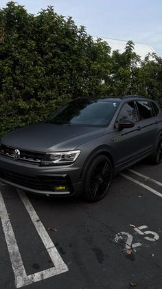 a grey volkswagen suv parked in a parking lot