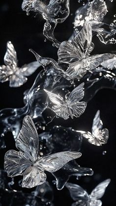 glass butterflies floating in the air with water splashing on it's wings and back