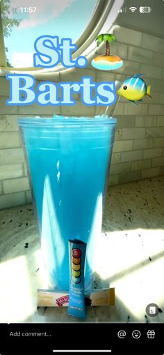 a blue liquid in a glass with a stick sticking out of it and the words st bart's above it