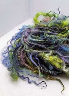 a pile of multicolored yarn sitting on top of a table